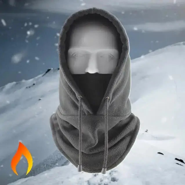 Cagoule capuche grise pour femme ou homme sur un fond de montagne enneigée, idéale pour protéger du froid en hiver et lors des activités outdoor.