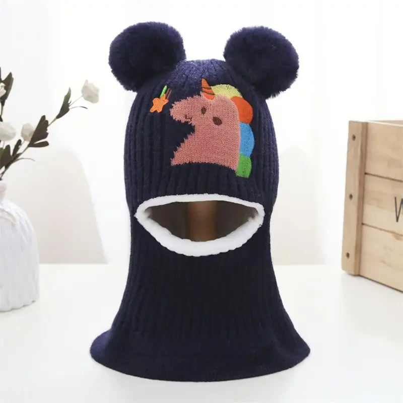 Cagoule enfant 4 ans bleue marine en laine douce avec oreilles rondes et broderie licorne colorée.