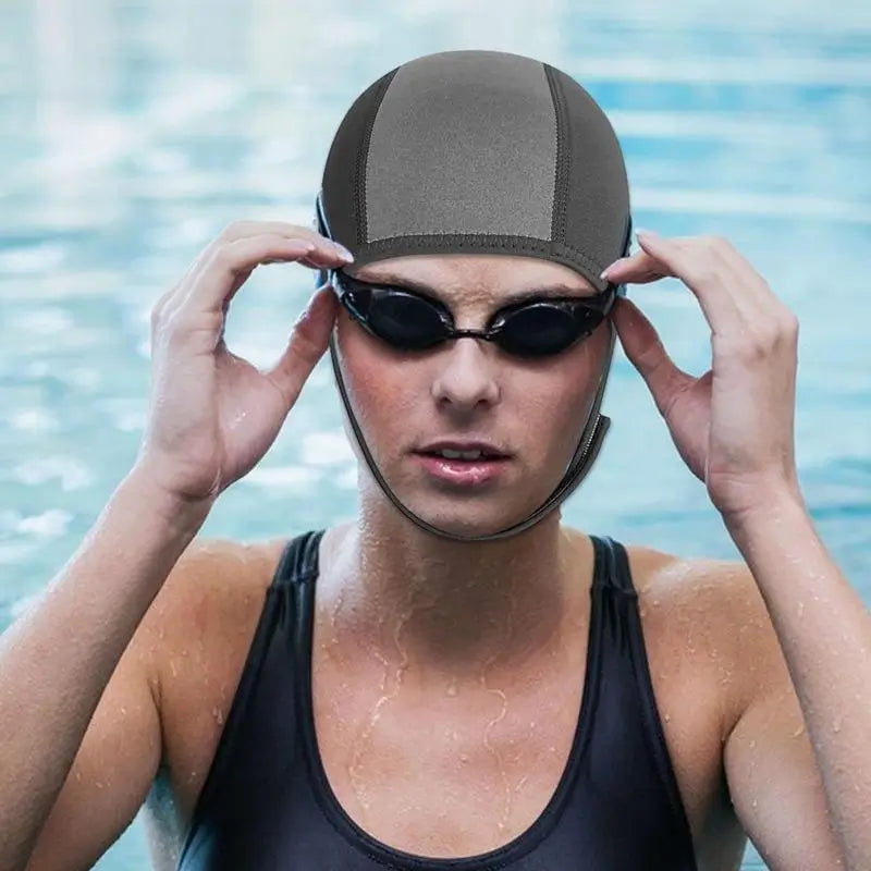 Nageuse équipée d'une cagoule néoprène de natation ou plongée en eau froide et de lunettes, idéale pour les séances de natation en eau froide ou en mer.