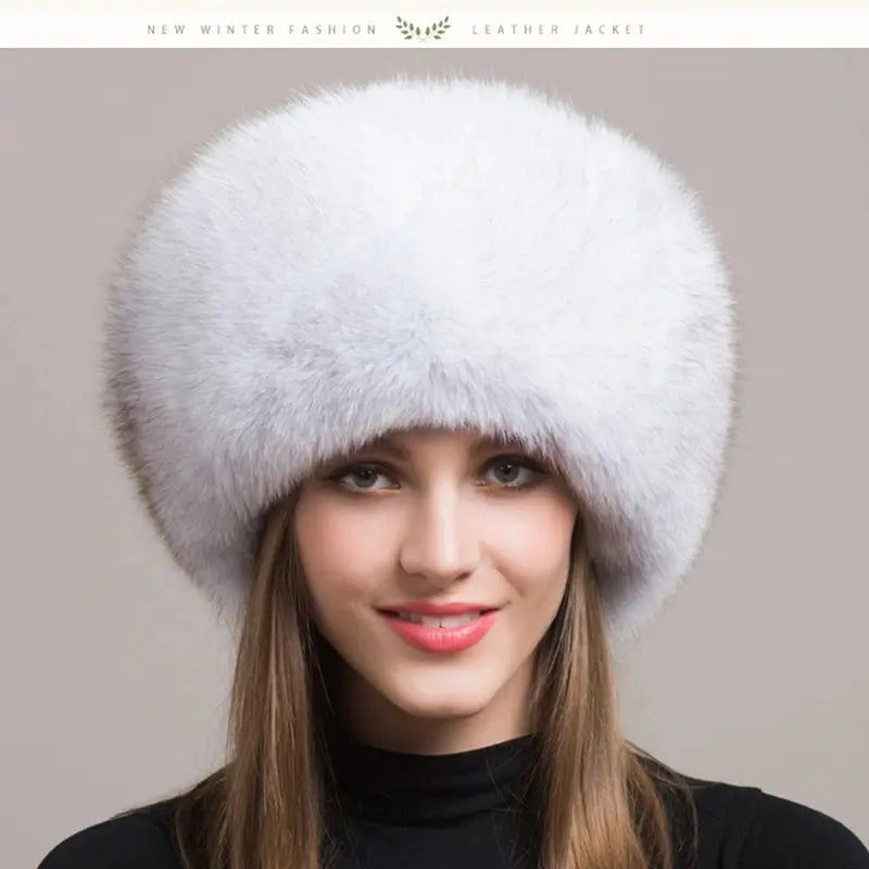 Femme élégante portant une Chapka Russe en vraie fourrure blanche natural fox, volumineuse et luxueuse. Un accessoire d’hiver raffiné, parfait pour une protection optimale contre le froid avec une touche sophistiquée.